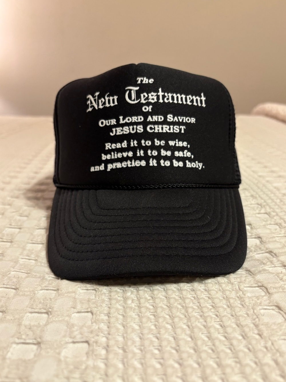 Black Trucker Hat with White 'New Testament' Script